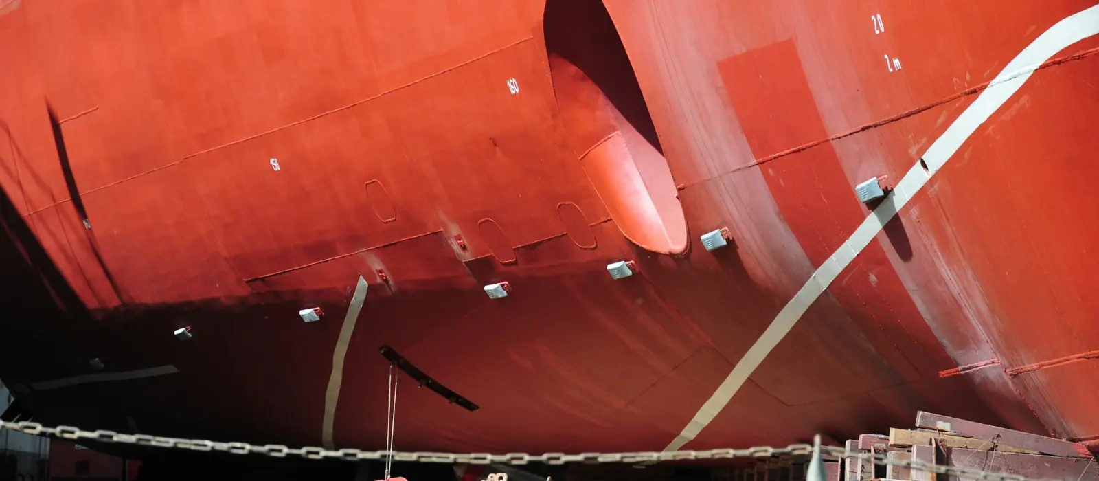 A ship's bow and hull on the blocks in dry dock